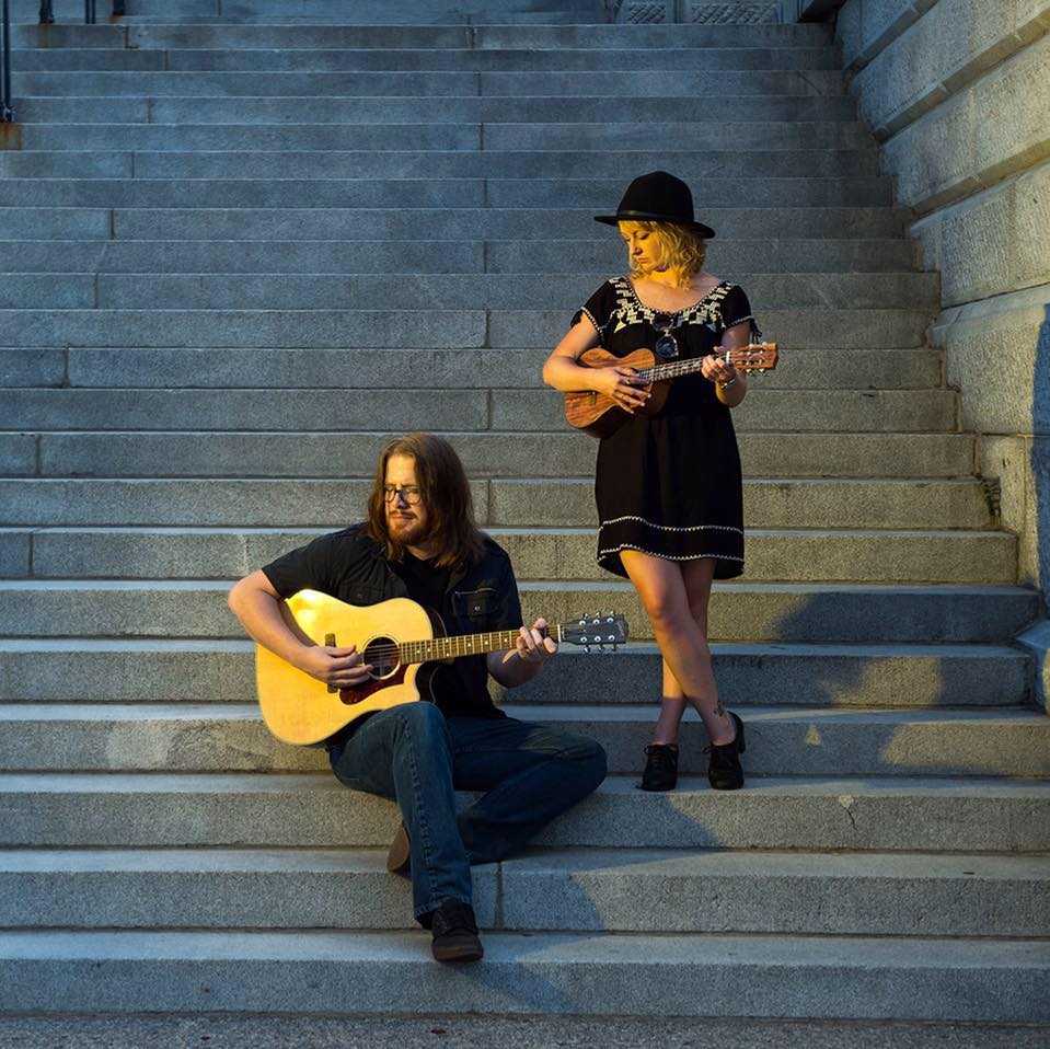 Man and a woman sitting on steps.