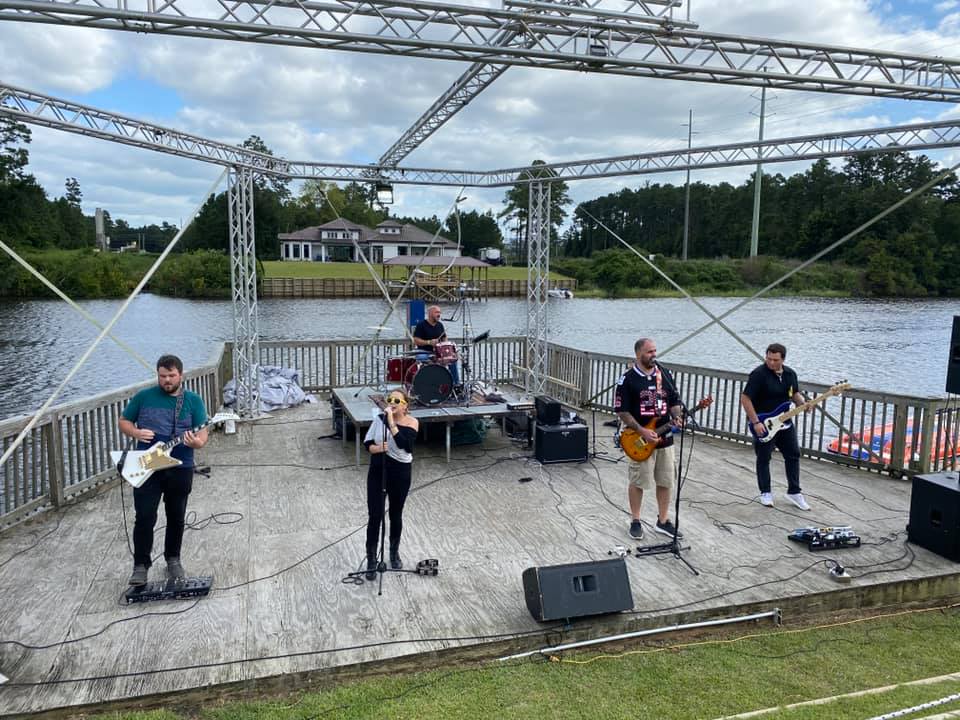 Band standing on stage preforming.