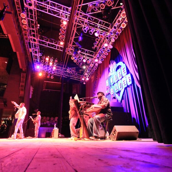 Band members of The Painted Man play on well lit stage for House of Blues performance